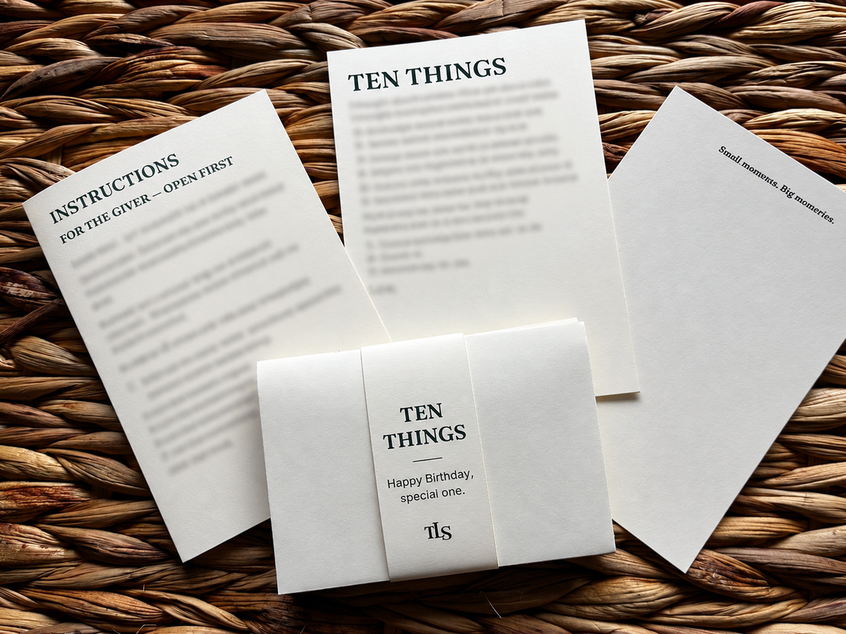 TEN THINGS birthday envelope bundle with giver instructions and printed cards on a woven surface